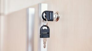Key lock with key hanging on door lock hardware, secure lock system, high-security door lock, modern home security, deepblue smart lock system.