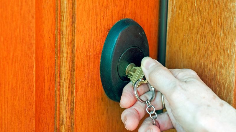 Secure home door lock with key inserted, showcasing modern security measures for safe living.