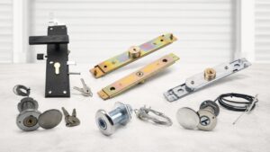 Various garage door lock components including ANLI lock, lock mechanisms, keys, and mounting hardware on a light surface.