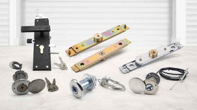 Various garage door lock components including ANLI lock, lock mechanisms, keys, and mounting hardware on a light surface.